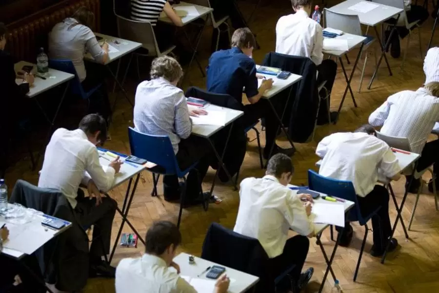 Students sitting public exams in an exam hall.
