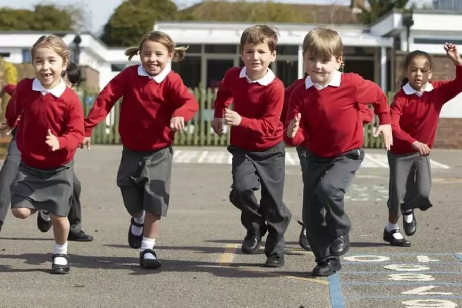 Happy children running in playground