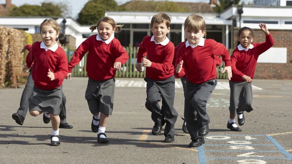 Five happy children at primary school.