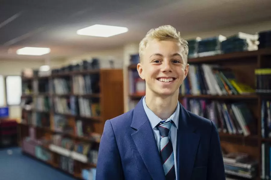 Happy GCSE boy in school library